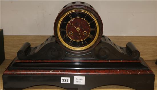 A late Victorian red and black marble eight day mantel clock